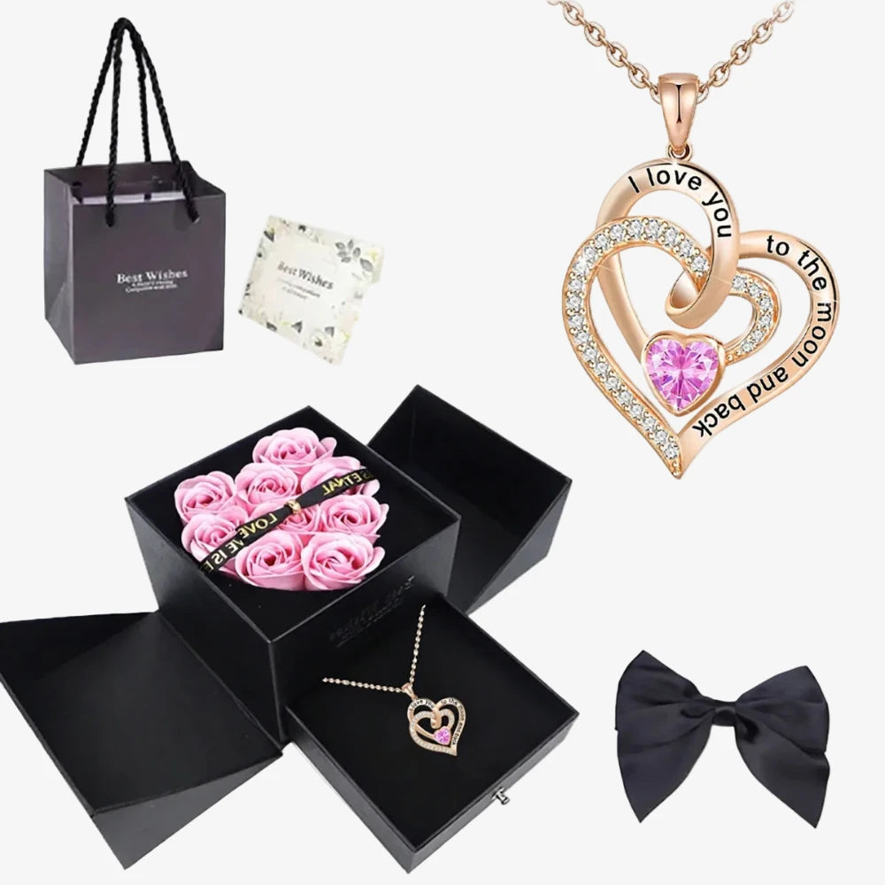 Coffret complet avec sac cadeau noir, boîte ouverte roses roses, pendentif cœur entrelacé or rose et nœud satin noir