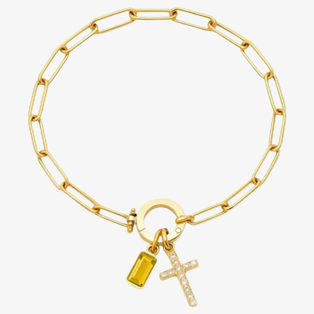 Pierre de naissance du mois de novembre sur une bracelet charms avec une croix en strass sur un fond neutre