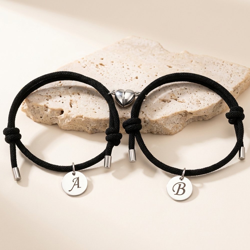 Bracelet de couple aimanté posé sur une pierre minérale ivoire
