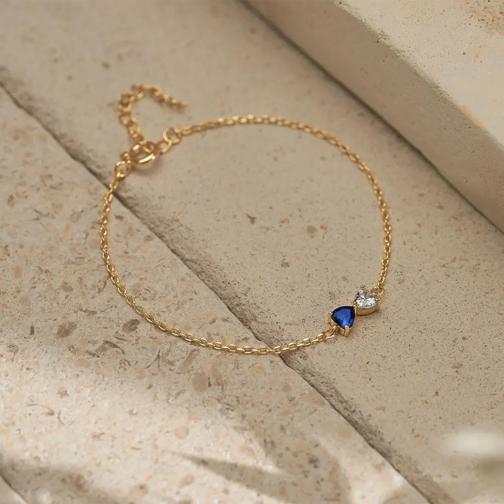 un bracelet de naissance duo coeur sur un fond de pierre naturel
