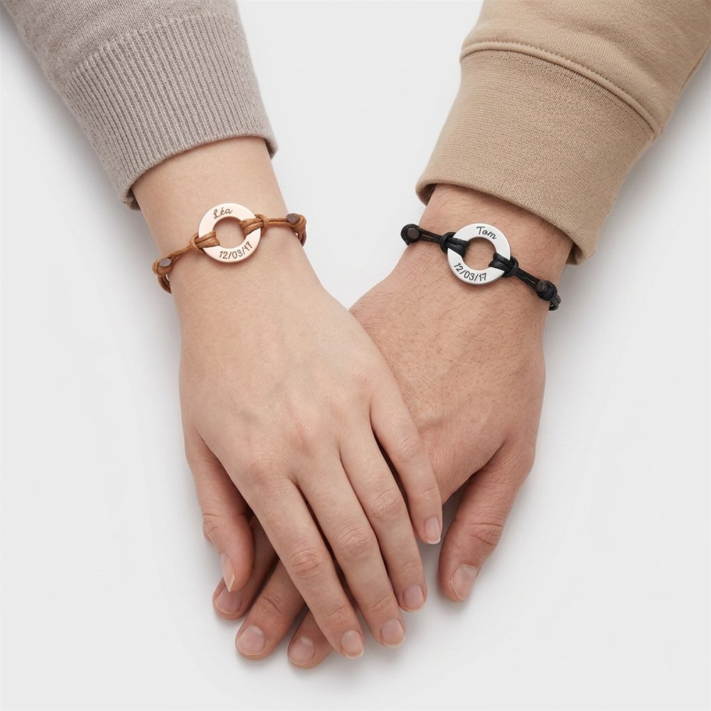 Bracelet duo couple personnalisé anneau porté par un couple main dans la main, un anneau gravé à chaque poignet