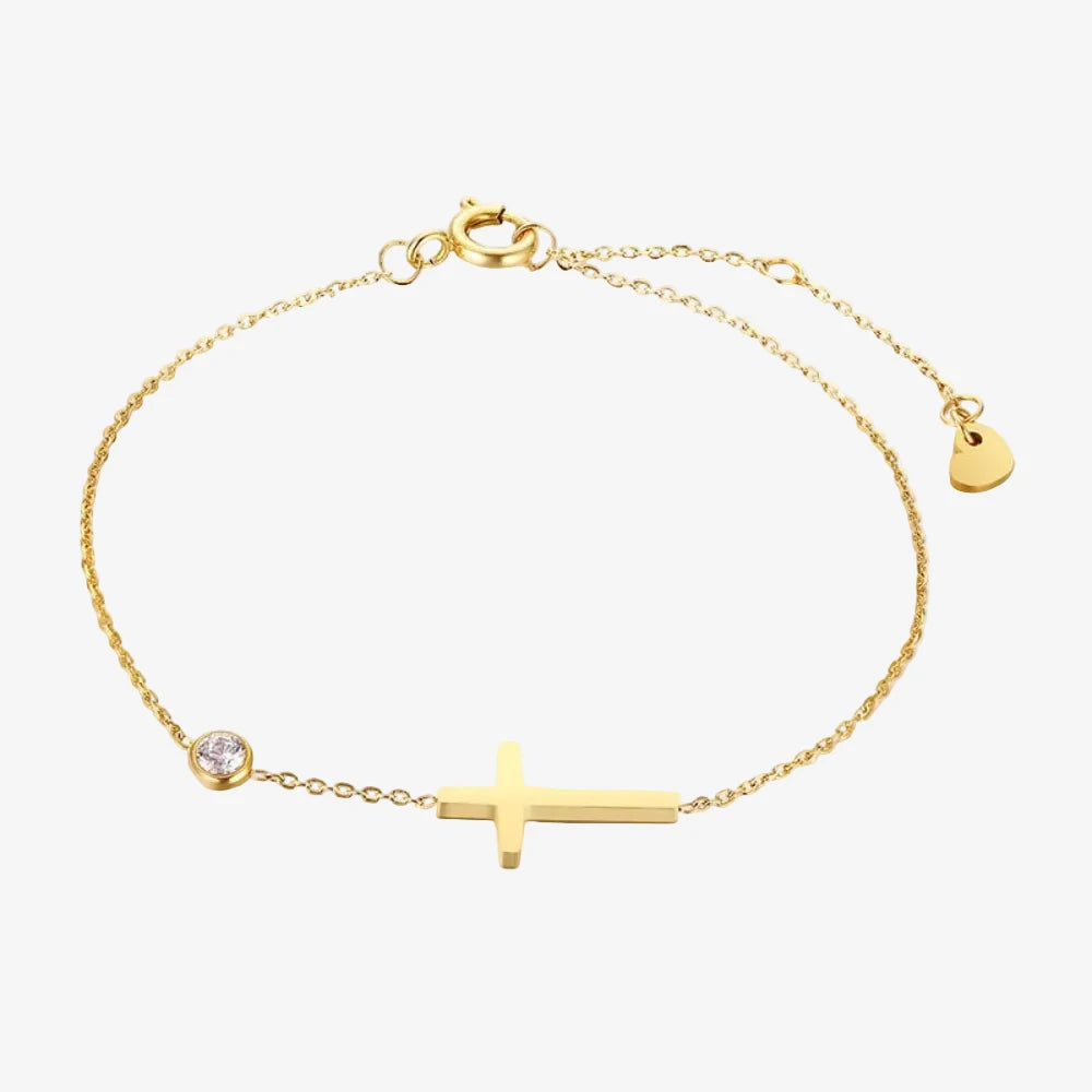 Bracelet avec une pierre de naissance et une croix. La pierre de naissance, c'est pour le mois d'avril. Le bracelet est sur un fond de 